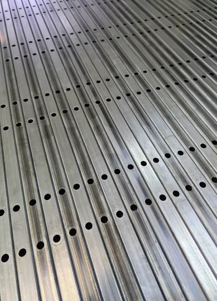 Aluminum profiles with cut-out holes.webp